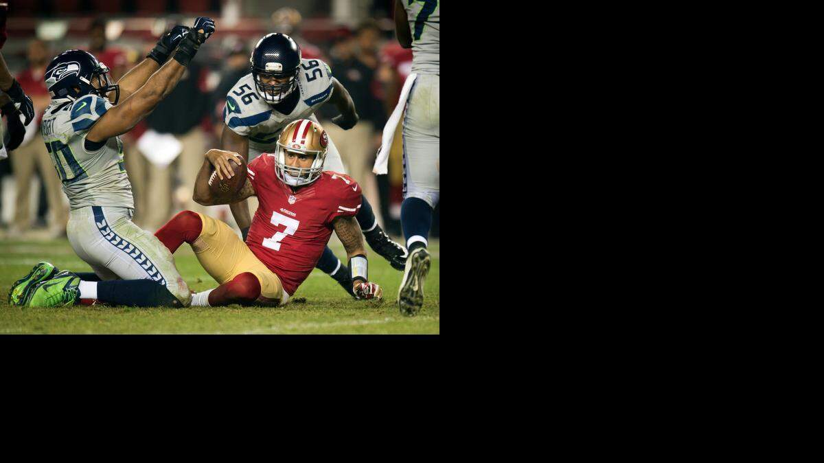 
Colin Kaepernick (7) is sacked by Seattle outside linebacker K.J. Wright (50) in the fourth quarter at Levi’s Stadium on Thursday, November 27, 2014 in Santa Clara, Calif.

