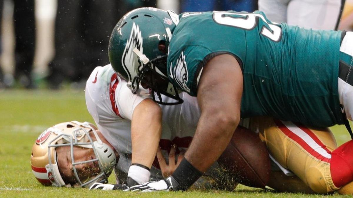 Quarterback C.J. Beathard is sacked by the Eagles’ Fletcher Cox on Sunday in Philadelphia during the 49ers’ 33-10 loss.