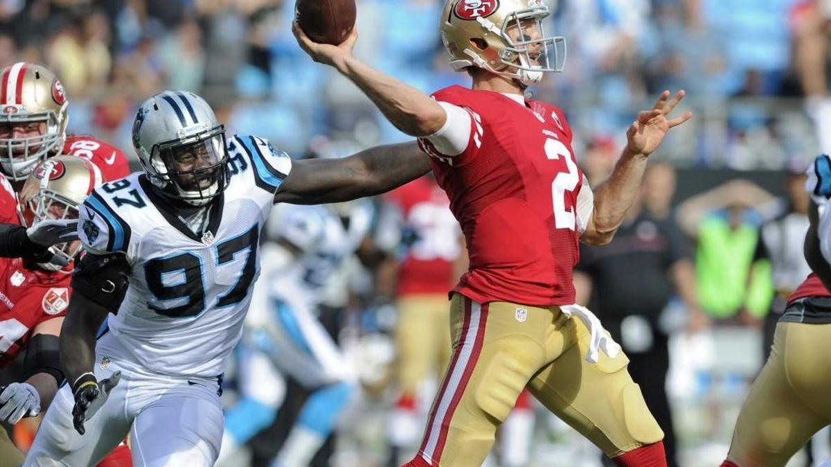 San Francisco 49ers quarterback Blaine Gabbert (2) looks to pass under pressure from Carolina Panthers defender Mario Addison (97) on Sunday, Sept. 18, 2016. The 49ers suffered a big loss in the game.