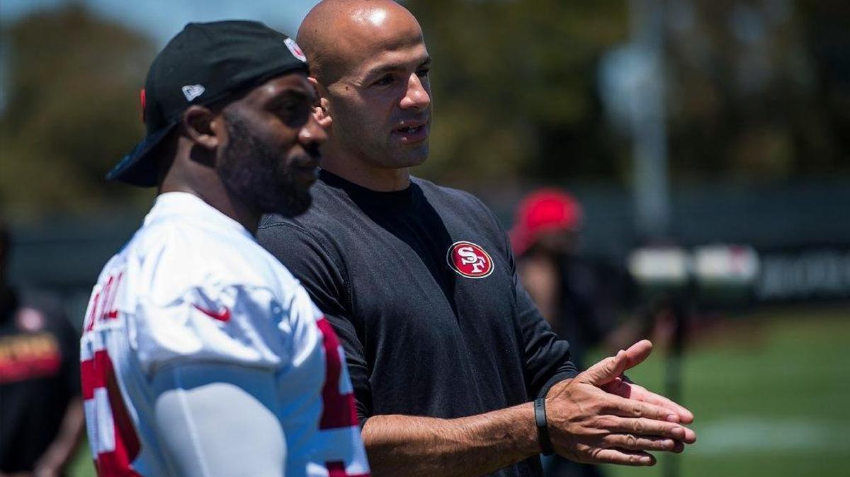 Robert Saleh, seen here with defensive end Elvis Dumervil, is entering his first year as 49ers defensive coordinator. Last year the team finished 32nd is nearly every major defensive category.