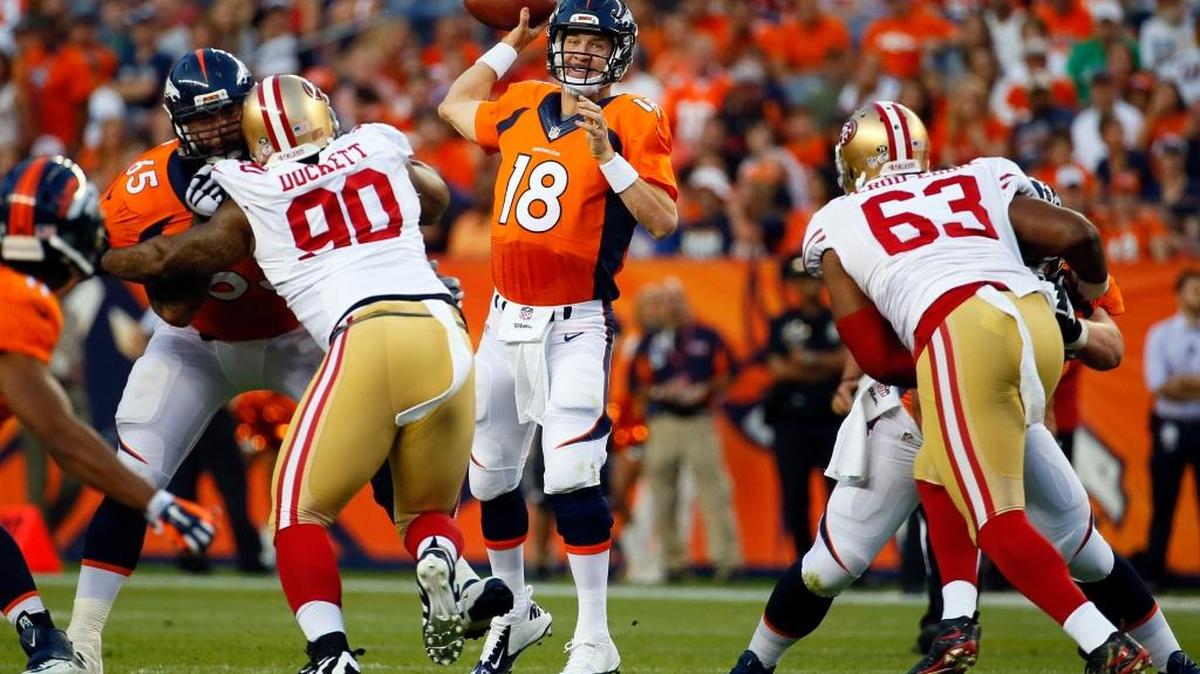 
Denver Broncos quarterback Peyton Manning (18) throws as San Francisco 49ers defensive tackle Darnell Dockett (90) and Tony Jerod-Eddie (63) pursue during the first half of an NFL preseason football game, Saturday, Aug. 29, 2015, in Denver. 
