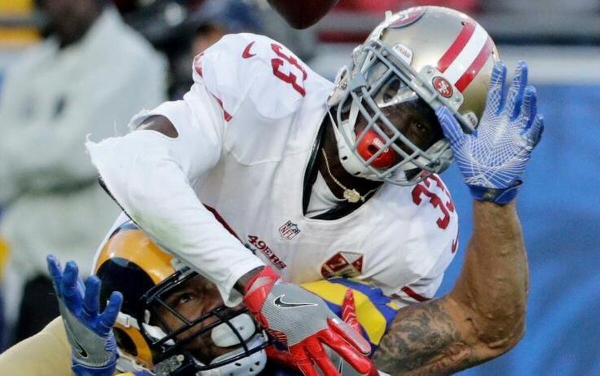 Rashard Robinson, top, breaks up a pass intended for Rams tight end Lance Kendricks on Dec. 24 in Los Angeles.