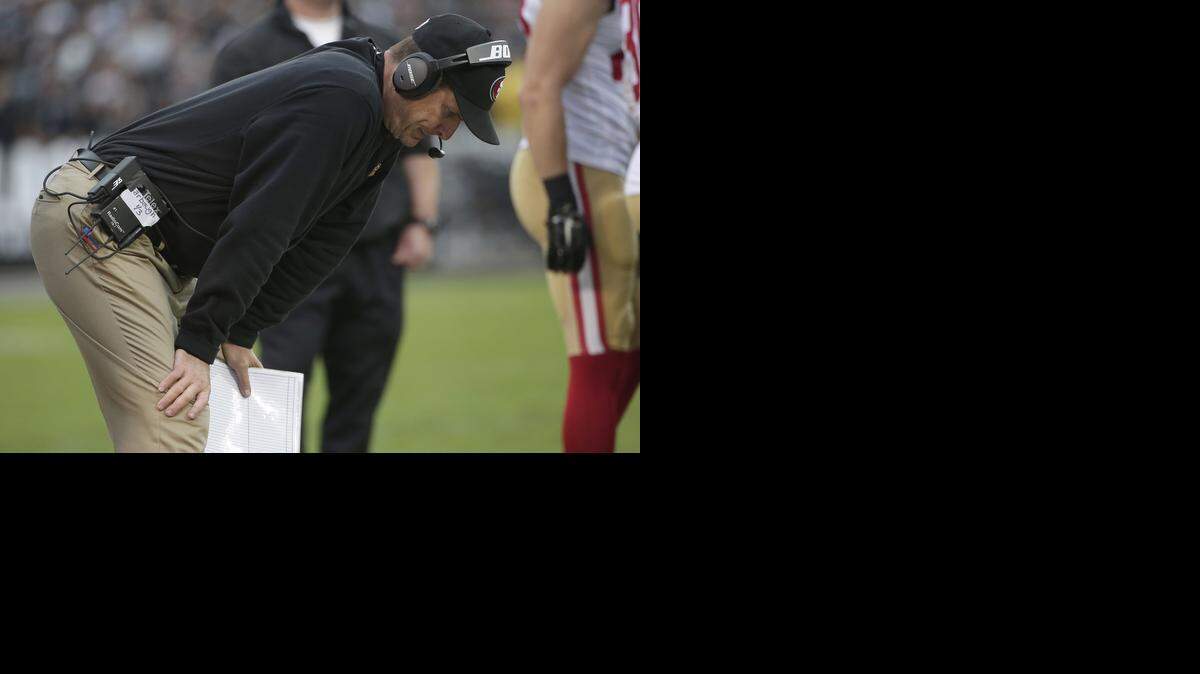 
San Francisco 49ers head coach Jim Harbaugh stands on the sideline during the second half of an NFL football game against the Oakland Raiders in Oakland., Sunday, Dec. 7, 2014.
