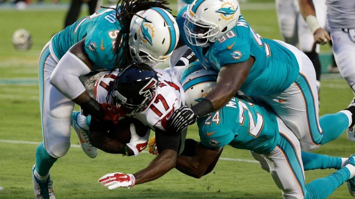 Atlanta Falcons wide receiver Devin Hester (17) is tackled by middle linebacker Kelvin Sheppard (52), defensive back Brice McCain (24) and defensive tackle Earl Mitchell (90) during the first half of a preseason NFL football game, Saturday, Aug. 29, 2015 in Miami Gardens, Fla.