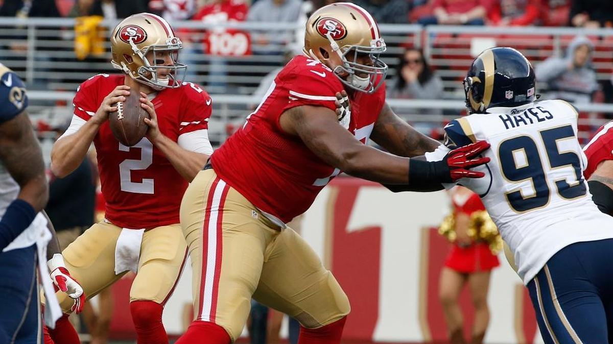 San Francisco 49ers quarterback Blaine Gabbert (2) passes as offensive tackle Trent Brown (77) blocks St. Louis Rams defensive end William Hayes (95) during the first half of an NFL football game in Santa Clara, Calif., Sunday, Jan. 3, 2016.