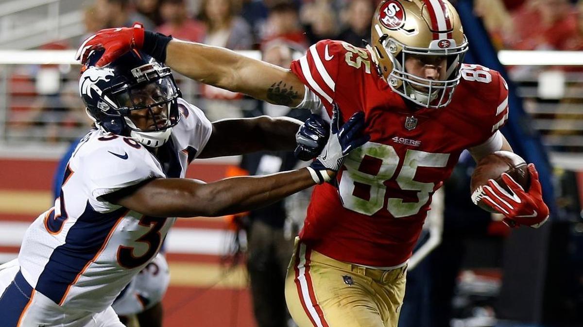 San Francisco 49ers tight end George Kittle (85) runs past Denver Broncos safety Orion Stewart on a touchdown reception during the second half of a preseason NFL football game Saturday, Aug. 19, 2017, in Santa Clara, Calif.