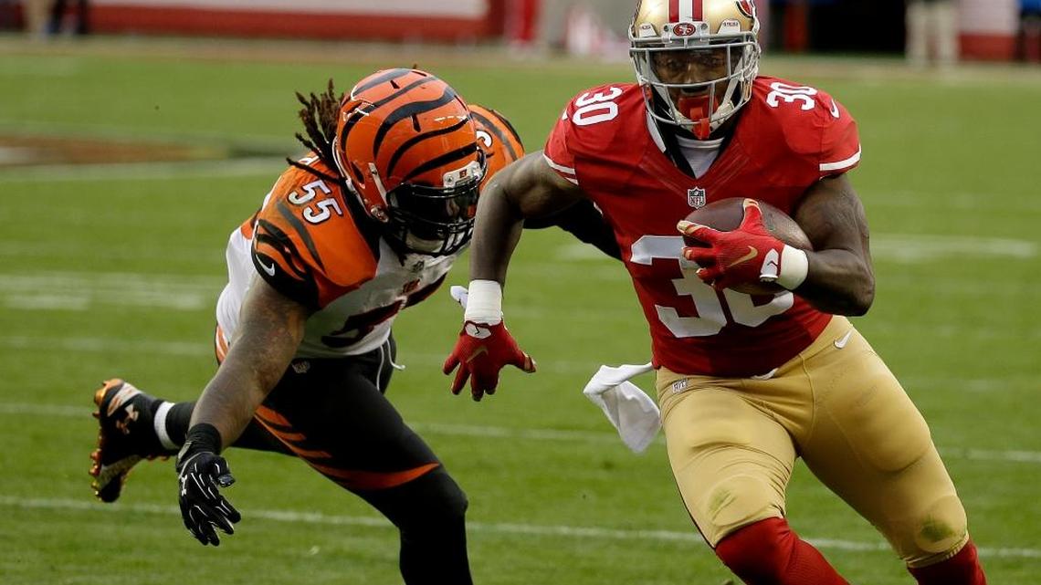 San Francisco 49ers running back Kendall Gaskins, right, runs past Cincinnati Bengals outside linebacker Vontaze Burfict during the second half of an NFL football game in Santa Clara, Calif., on Sunday, Dec. 20, 2015.