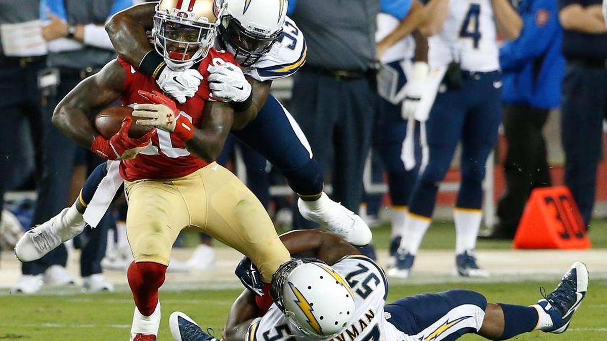 
San Francisco 49ers' Bruce Ellington (10) is tackled by San Diego Chargers' Kavell Conner, top, and Denzel Perryman (52) during the first half of an NFL preseason football game in Santa Clara, Calif., Thursday, Sept. 3, 2015. 
