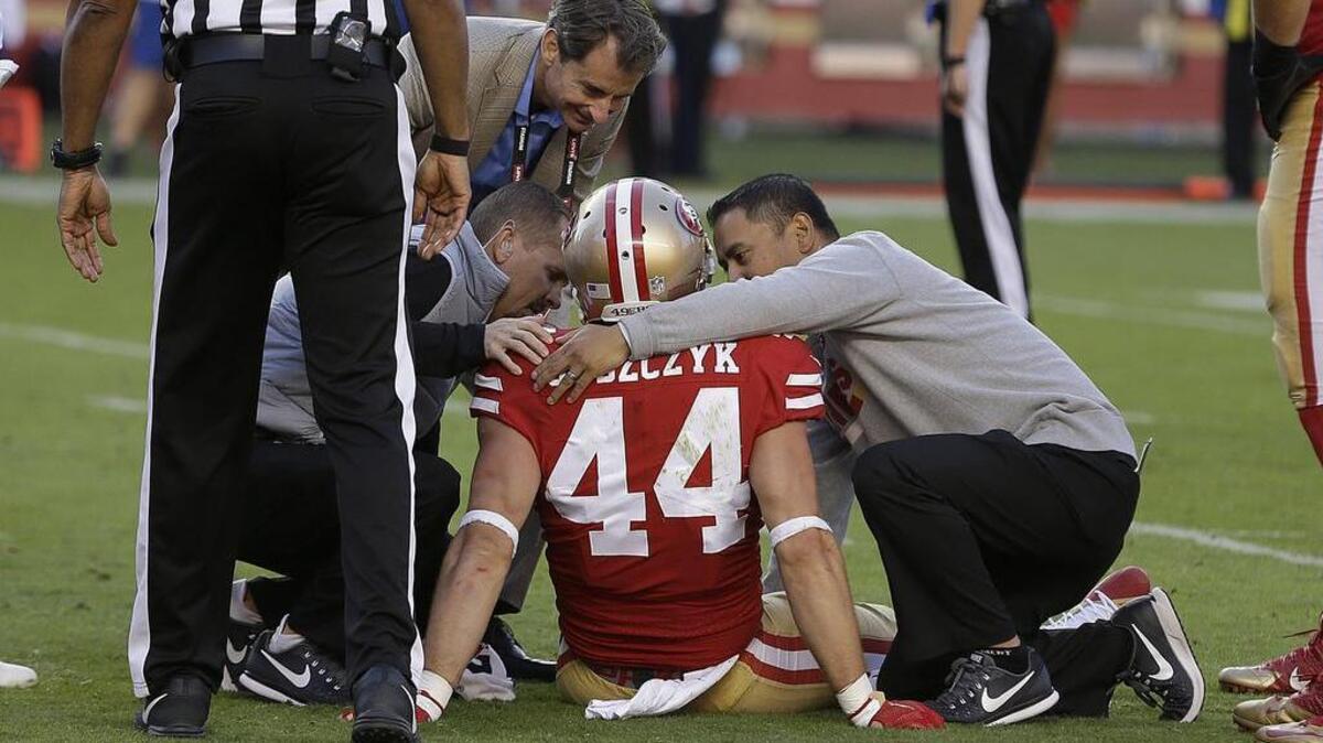 San Francisco 49ers fullback Kyle Juszczyk (44) is tended to by trainers during the second half of an NFL football game between the 49ers and the Arizona Cardinals in Santa Clara, Calif., Sunday, Nov. 5, 2017.