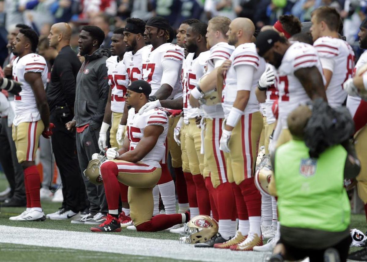 San Francisco 49ers strong safety Eric Reid kneels during the singing of the national anthem before an NFL football game against the Seattle Seahawks, Sunday, Sept. 17, 2017, in Seattle.