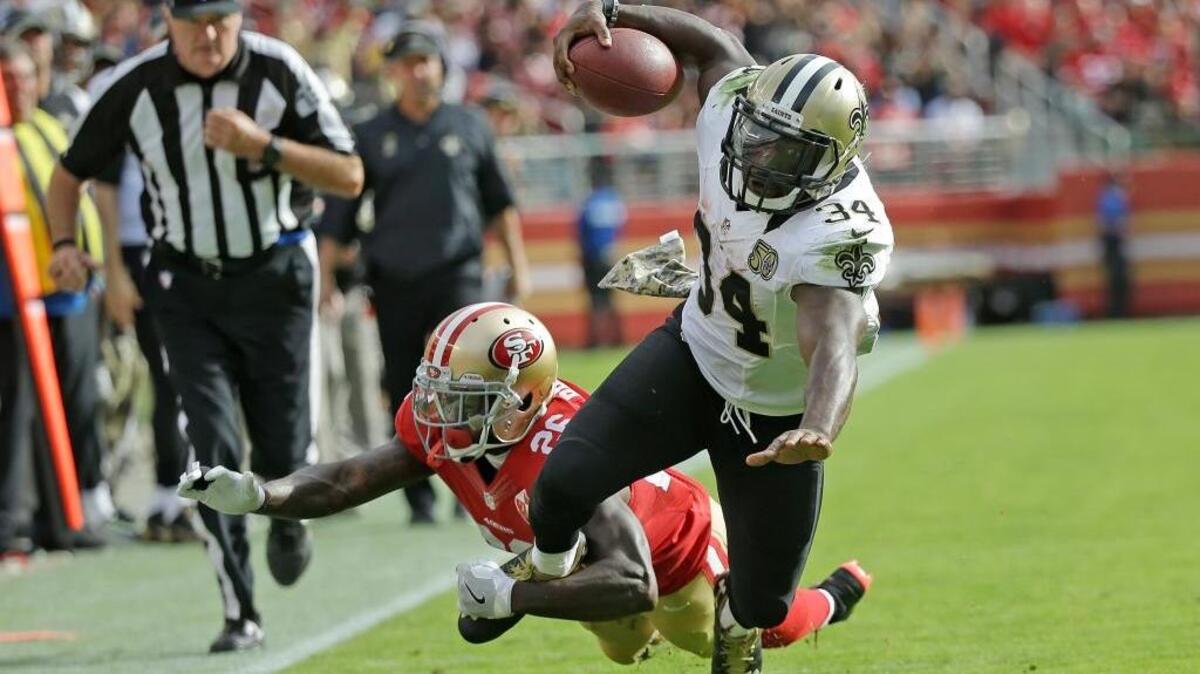 New Orleans Saints running back Tim Hightower goes tumbling with ball while being stopped by San Francisco 49ers cornerback Tramaine Brock, left, during the first half of an NFL football game Sunday, Nov. 6, 2016, in Santa Clara, Calif.