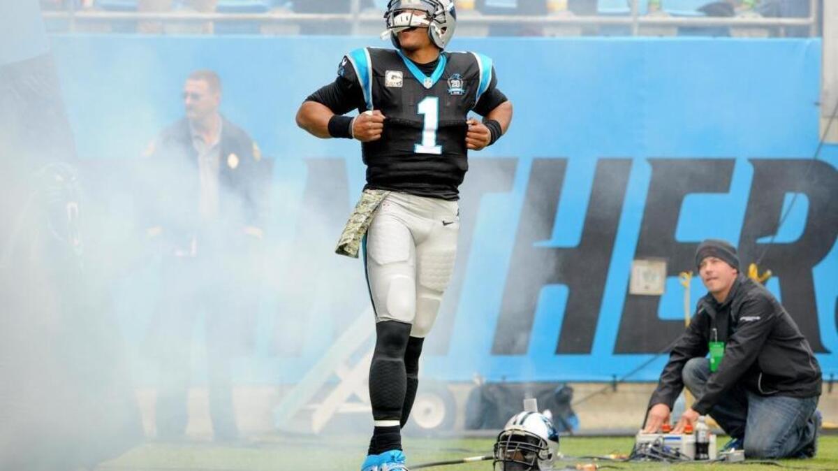 Carolina Panthers quarterback Cam Newton walks onto the field during player introductions before a game against the Atlanta Falcons in Charlotte, N.C., on Nov. 16, 2014.