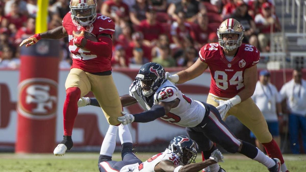 San Francisco 49ers running back Mike Davis gets past Houston Texans free safety Andre Hal (29) and defensive back Robert Nelson (32) for a short gain in the first half quarter on Sunday afternoon in the NFL pre-season game between the San Francisco 49ers and Houston Texans.
