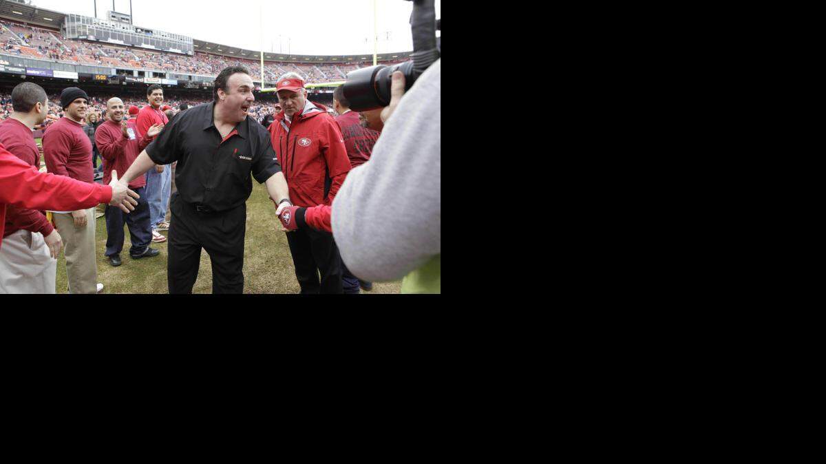 
In this photo taken Jan. 2, 2011, San Francisco 49ers interim head coach Jim Tomsula, center, greets fans before an NFL football game between the 49ers and the Arizona Cardinals in San Francisco.
