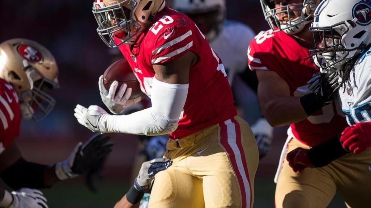 Carlos Hyde gains yardage in the second quarter against the Tennessee Titans at Levi's Stadium in Santa Clara on Sunday.