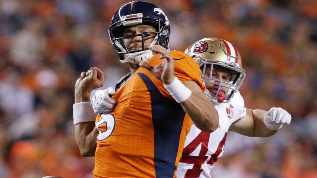Denver Broncos quarterback Mark Sanchez fumbles as he is sacked by San Francisco 49ers linebacker Marcus Rush, right, during the first half of a preseason NFL football game, Saturday, Aug. 20, 2016, in Denver. The 49ers recovered the fumble.