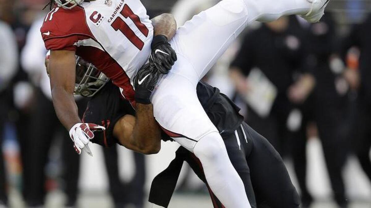 Cardinals wide receiver Larry Fitzgerald is tackled by 49ers linebacker Michael Wilhoite in the first half Thursday at Levi’s Stadium. The 49ers’ defensive line was missing Glenn Dorsey and DeForest Buckner because of injuries.