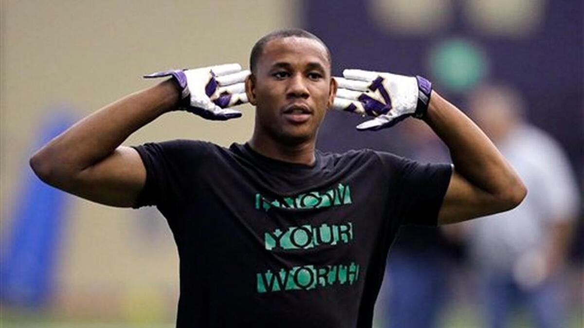 Former Washington player Marcus Peters motions as he works out at Washington's pro day Thursday, April 2, 2015, in Seattle.