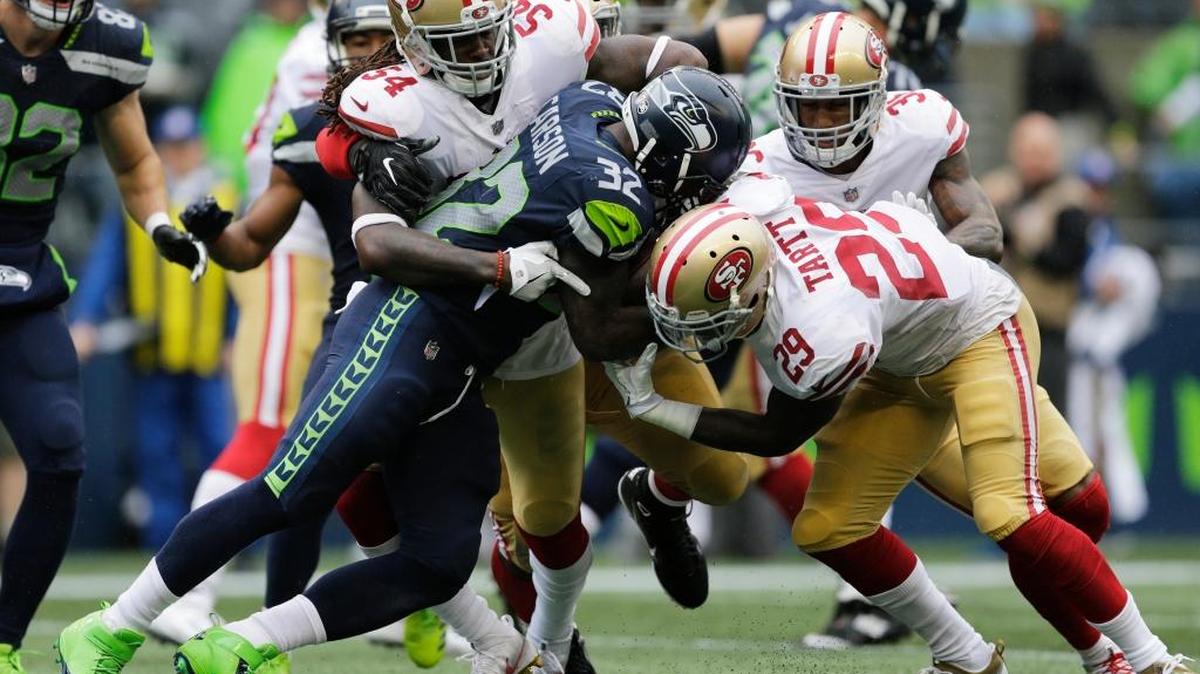 Seattle Seahawks running back Chris Carson (32) rushes against San Francisco 49ers free safety Jaquiski Tartt (29) as he is tackled by 49ers' Ray-Ray Armstrong (54) in the second half of an NFL football game, Sunday, Sept. 17, 2017, in Seattle.