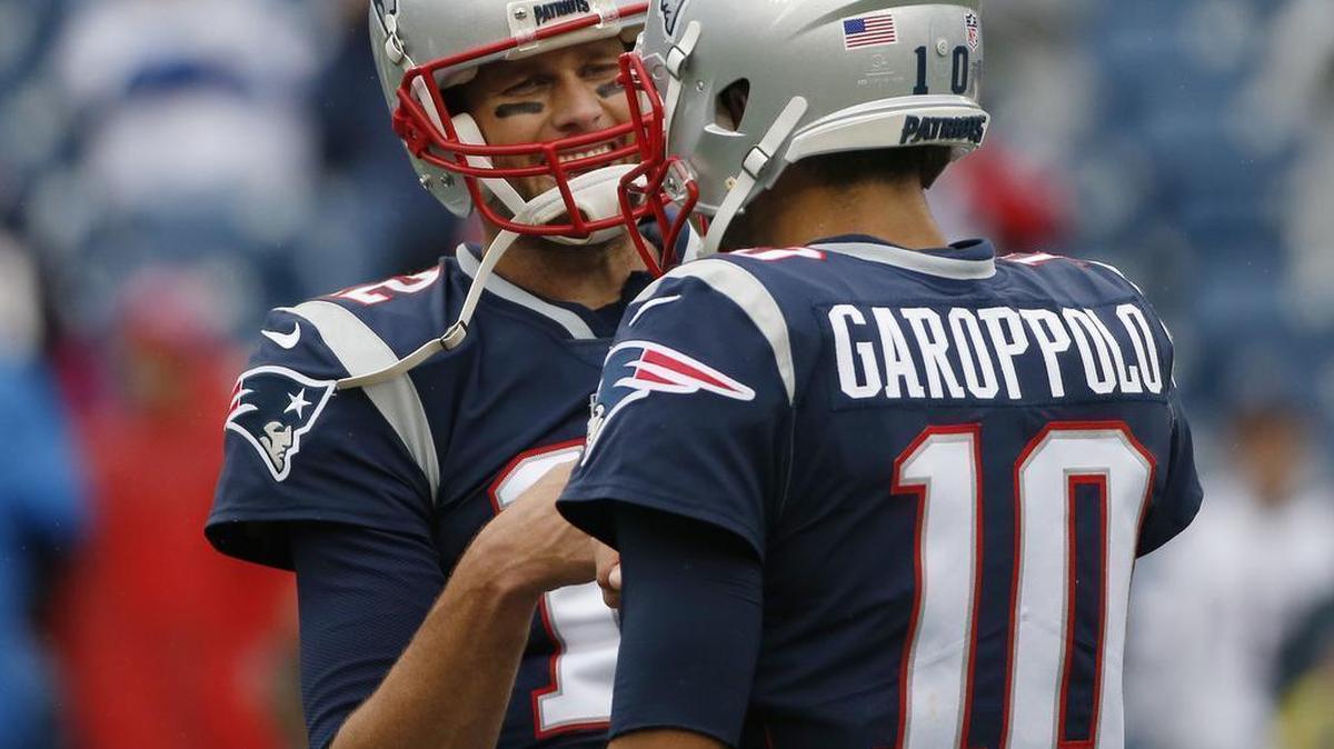 New England Patriots quarterbacks Tom Brady, left, and Jimmy Garoppolo warm up before an NFL football game against the Los Angeles Chargers, Sunday, Oct. 29, 2017, in Foxborough, Mass.