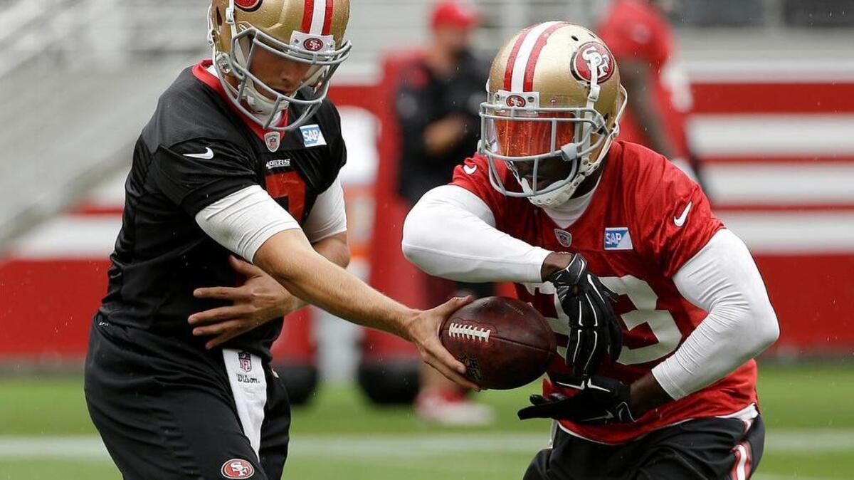 
San Francisco 49ers quarterback Blaine Gabbert, left, hands off to running back Reggie Bush during an NFL football mini-camp in Santa Clara, Calif., Wednesday, June 10, 2015. 
