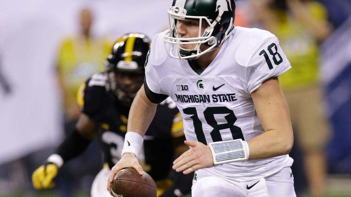 Michigan State quarterback Connor Cook (18) scrambles out of the pocket against Iowa during the first half of the Big Ten Conference championship NCAA college football game Saturday, Dec. 5, 2015, in Indianapolis.