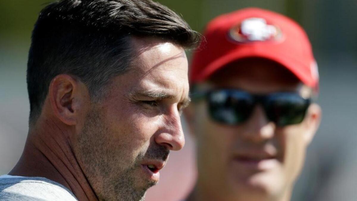 San Francisco 49ers head coach Kyle Shanahan, left, watches practice with general manager John Lynch during NFL football training camp Friday, July 28, 2017, in Santa Clara, Calif.