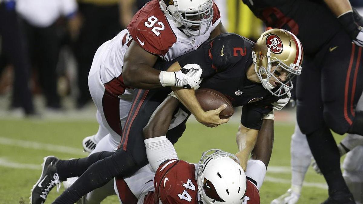 San Francisco’s Blaine Gabbert is sacked by Cardinals linebacker Markus Golden (44) as defensive end Frostee Rucker (92) assists. Gabbert had been sacked only three times in four games before Thursday, when he was sacked seven times.