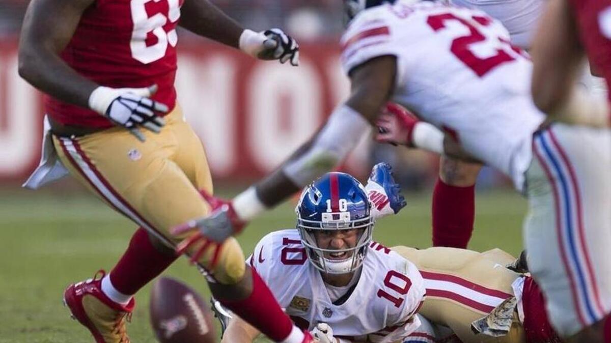 New York Giants starting quarterback Eli Manning (10) fumbles the ball after a hit by San Francisco 49ers Ronald Blair III. The ball is recovered by the San Francisco 49ers in the second quarter during a game at Levi's Stadium in Santa Clara, Calif. on Sunday, Nov. 12, 2017.