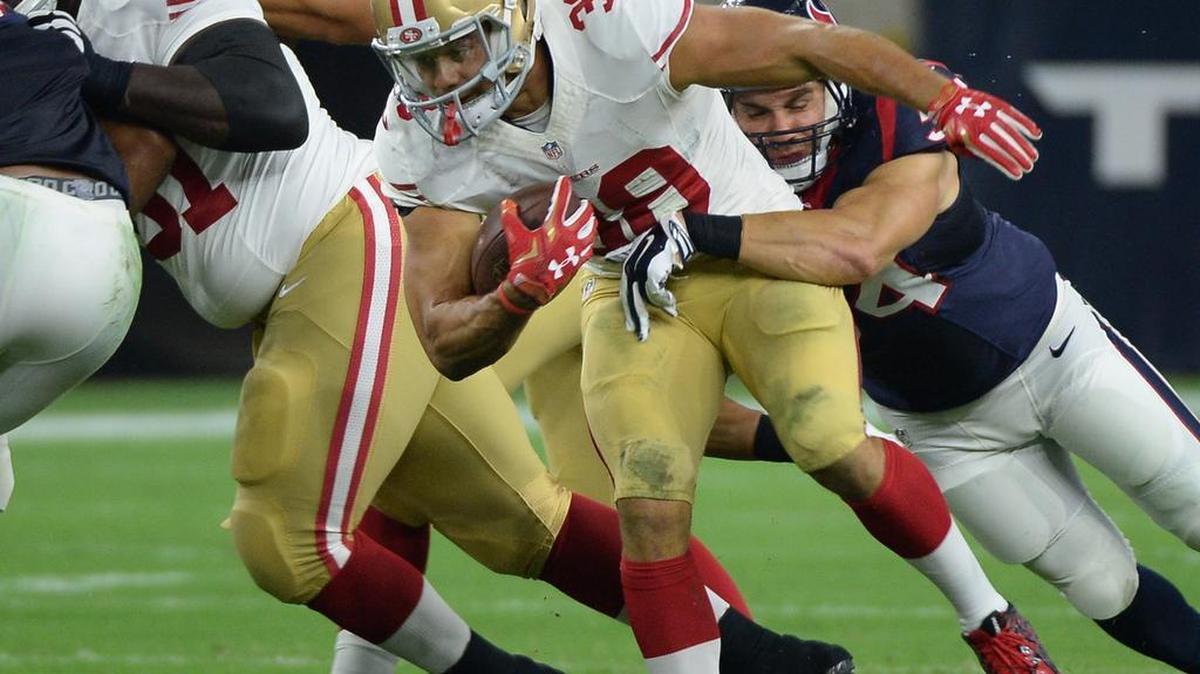 
San Francisco 49ers' Jarryd Hayne (38) is stopped during the first half of an NFL preseason football game against the Houston Texans Saturday, Aug. 15, 2015, in Houston. 
