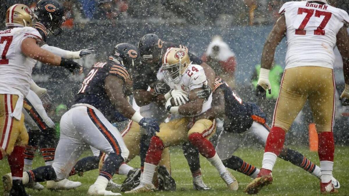 San Francisco 49ers running back Shaun Draughn (24) is tackled by Chicago Bears defenders during the first half of an NFL football game, Sunday, Dec. 4, 2016, in Chicago.