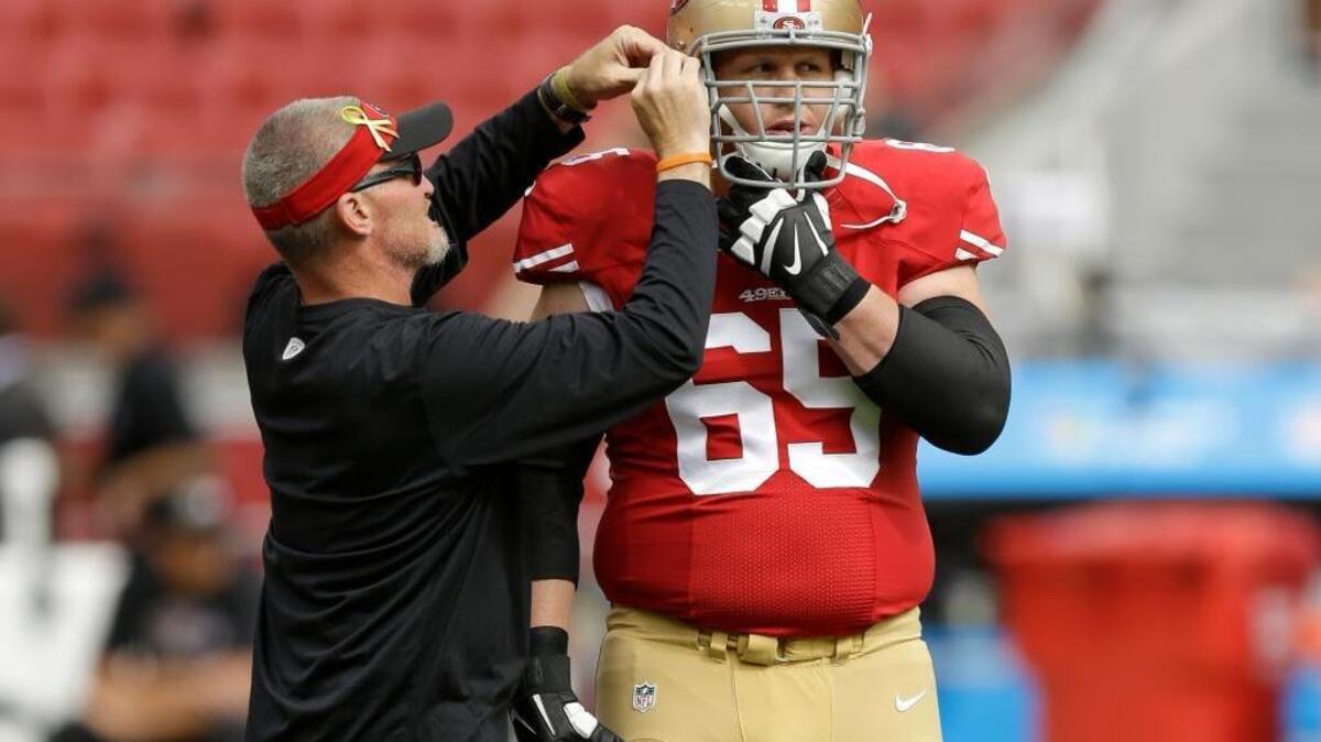 San Francisco 49ers offensive lineman Jordan Devey (65) has his helmet adjusted before an NFL football game against the Baltimore Ravens in Santa Clara, Calif., Sunday, Oct. 18, 2015.