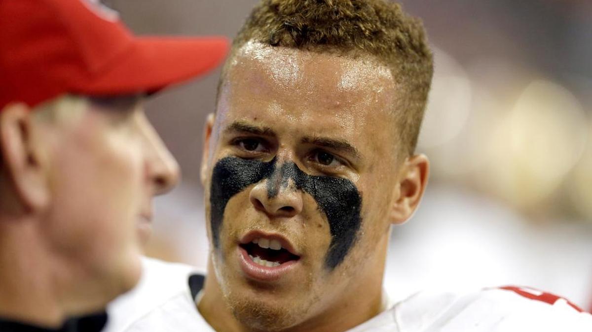 
San Francisco 49ers inside linebacker Shayne Skov talks to a coach on the sideline during the second quarter of an NFL football preseason game against the Houston Texans Thursday, Aug. 28, 2014, in Houston. 
