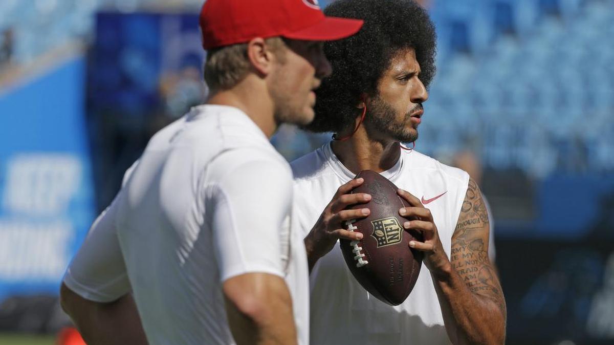 San Francisco 49ers' Blaine Gabbert, left, and Colin Kaepernick, right, warm up before an NFL football game against the Carolina Panthers in Charlotte, N.C., Sunday, Sept. 18, 2016.