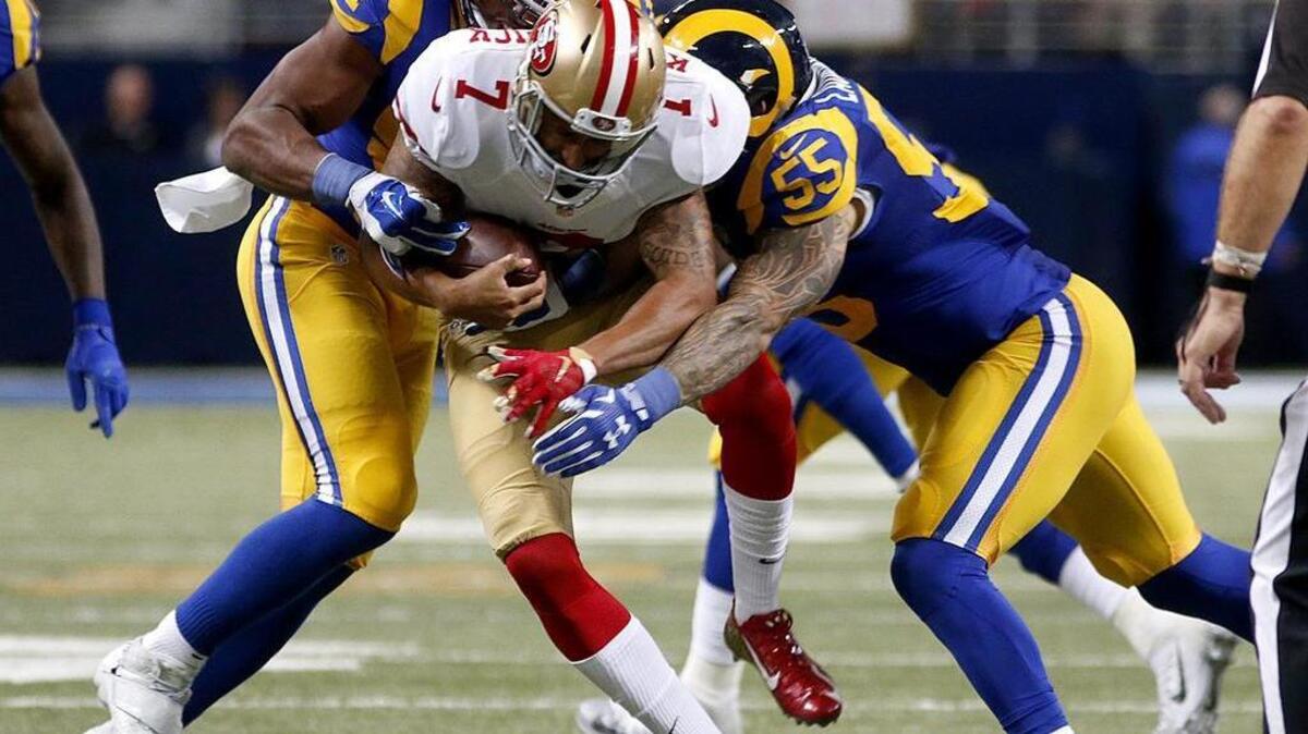 Robert Quinn (left) and James Laurinaitis sack 49ers quarterback Colin Kaepernick Sunday in the win over the 49ers in St. Louis.