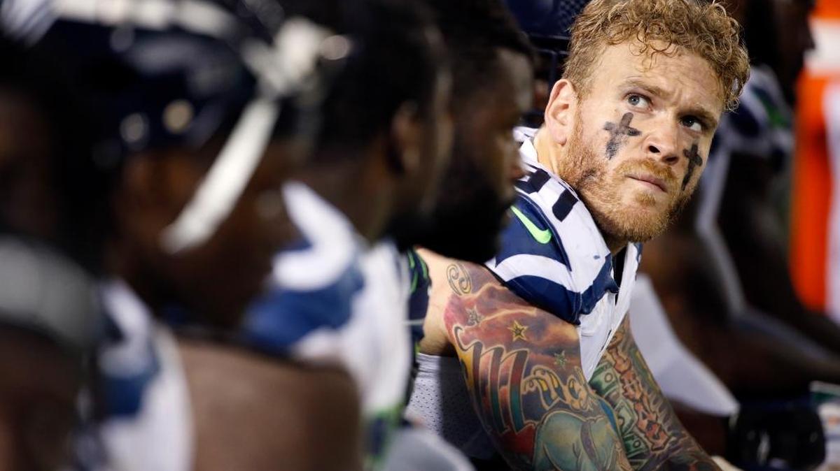 Seattle Seahawks defensive end Cassius Marsh, right, watches from the sideline during the second half of a preseason NFL football game against the Oakland Raiders on Thursday, Sept. 1, 2016, in Oakland, Calif.