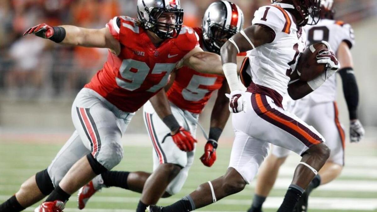 Ohio State lineman Joey Bosa (97) and linebacker Raekwon McMillian (5) chase Virginia Tech receiver Isaiah Ford (1) during an NCAA college football game in Columbus, Ohio.