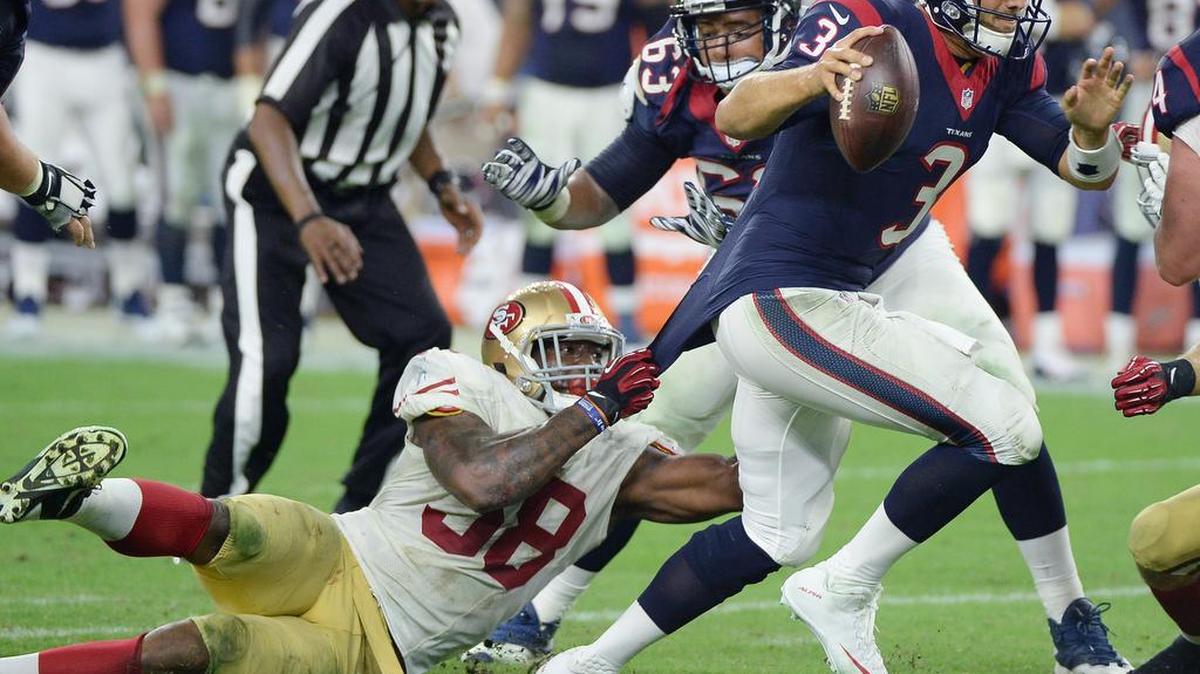 
Houston Texans' Tom Savage (3) is pulled down by San Francisco 49ers' Eli Harold, left, during the second half of an NFL preseason football game, Saturday, Aug. 15, 2015, in Houston. 
