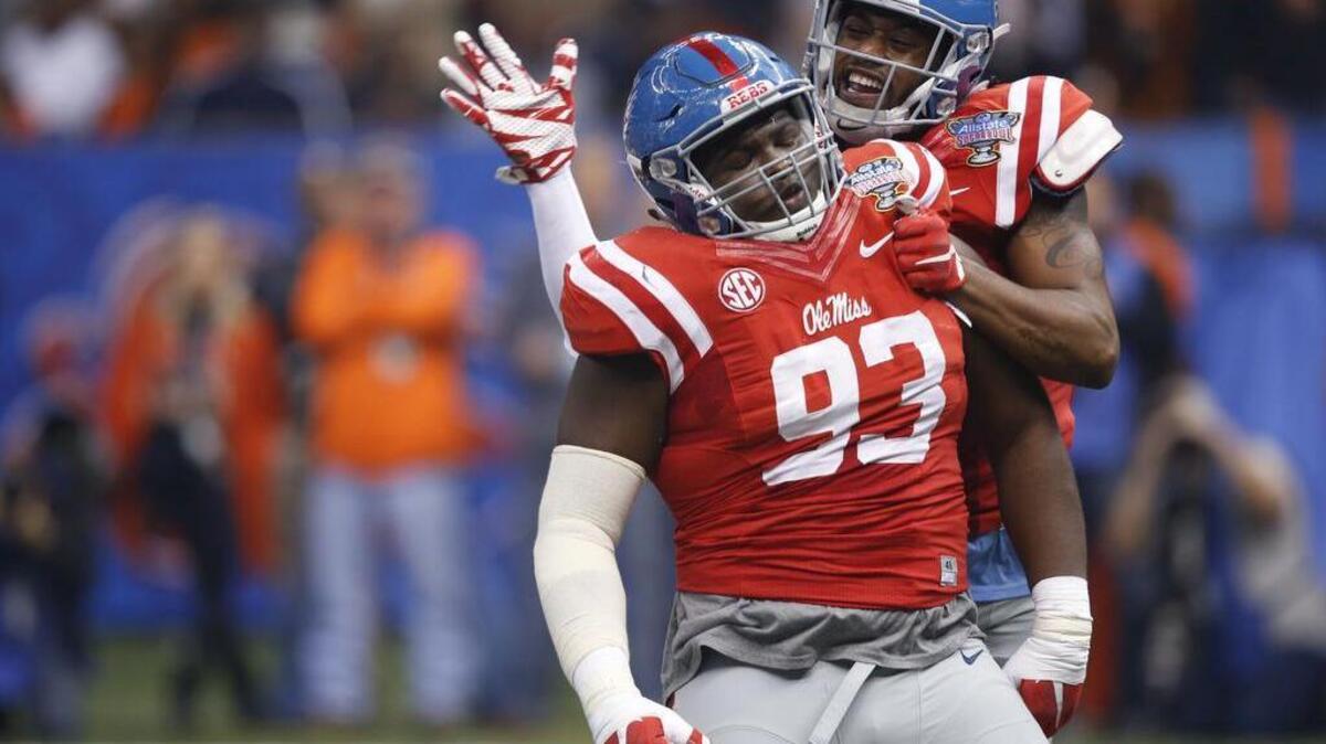 Mississippi defensive tackle D.J. Jones (93) celebrates his sack with linebacker C.J. Johnson in the first half of the Sugar Bowl college football game against Oklahoma State in New Orleans, Friday, Jan. 1, 2016.