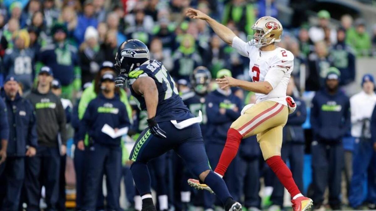 San Francisco 49ers quarterback Blaine Gabbert, right, gets a pass off against the Seattle Seahawks in the second half of an NFL football game, Sunday, Nov. 22, 2015, in Seattle.