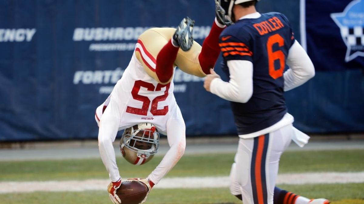 San Francisco 49ers strong safety Jimmie Ward (25) dives to the end zone for a touchdown after intercepting a pass as Chicago Bears quarterback Jay Cutler (6) watches during the first half of an NFL football game, Sunday, Dec. 6, 2015, in Chicago.