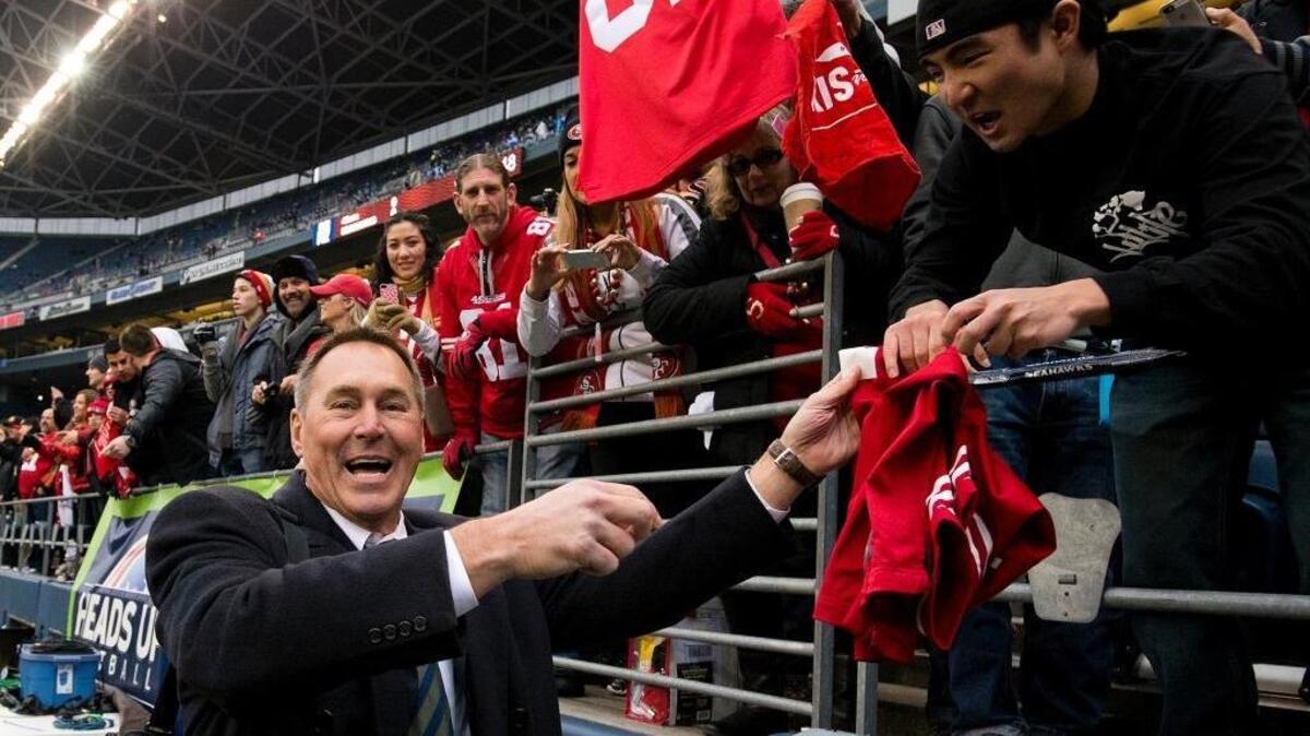Former 49ers wide receiver Dwight Clark sign autographs before the NFC championship game between the San Francisco 49ers and the Seattle Seahawks at CenturyLink Field in Seattle on Jan. 19, 2014.