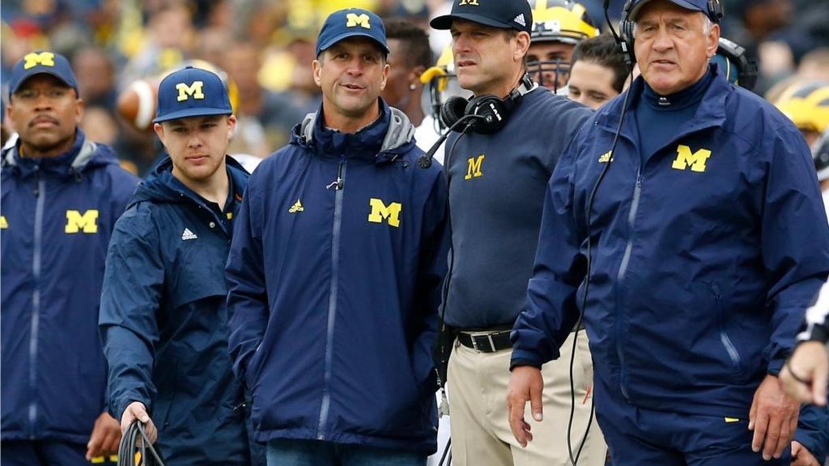 
Baltimore Ravens head coach John Harbaugh, left, stands alongside his brother, Michigan head coach Jim Harbaugh, in the first half of an NCAA college football game against Maryland, Saturday, Oct. 3, 2015, in College Park, Md. 
