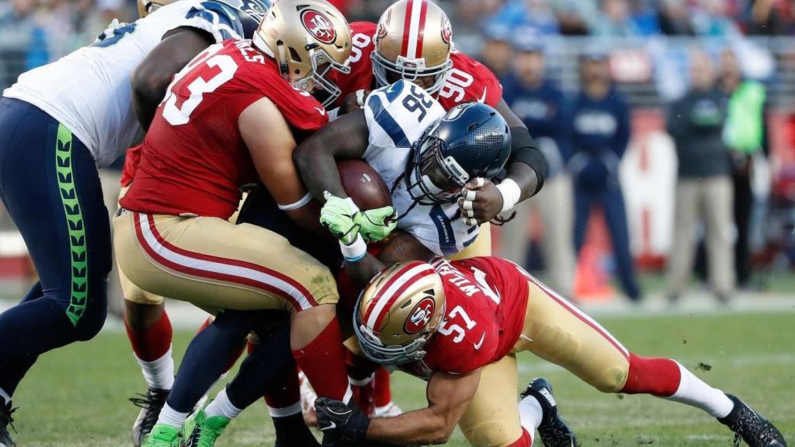 Seattle Seahawks running back Alex Collins (36) is tackled by San Francisco 49ers defensive tackle Chris Jones (93), nose tackle Glenn Dorsey (90) and linebacker Michael Wilhoite (57) during the second half of an NFL football game in Santa Clara, Calif., Sunday, Jan. 1, 2017.