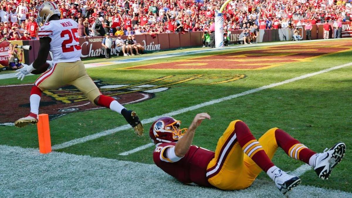 San Francisco 49ers free safety Jimmie Ward (25) is knocked out of bound just shy of the goal line by Washington Redskins quarterback Kirk Cousins after Ward recovered a fumble Sunday in Landover, Md.