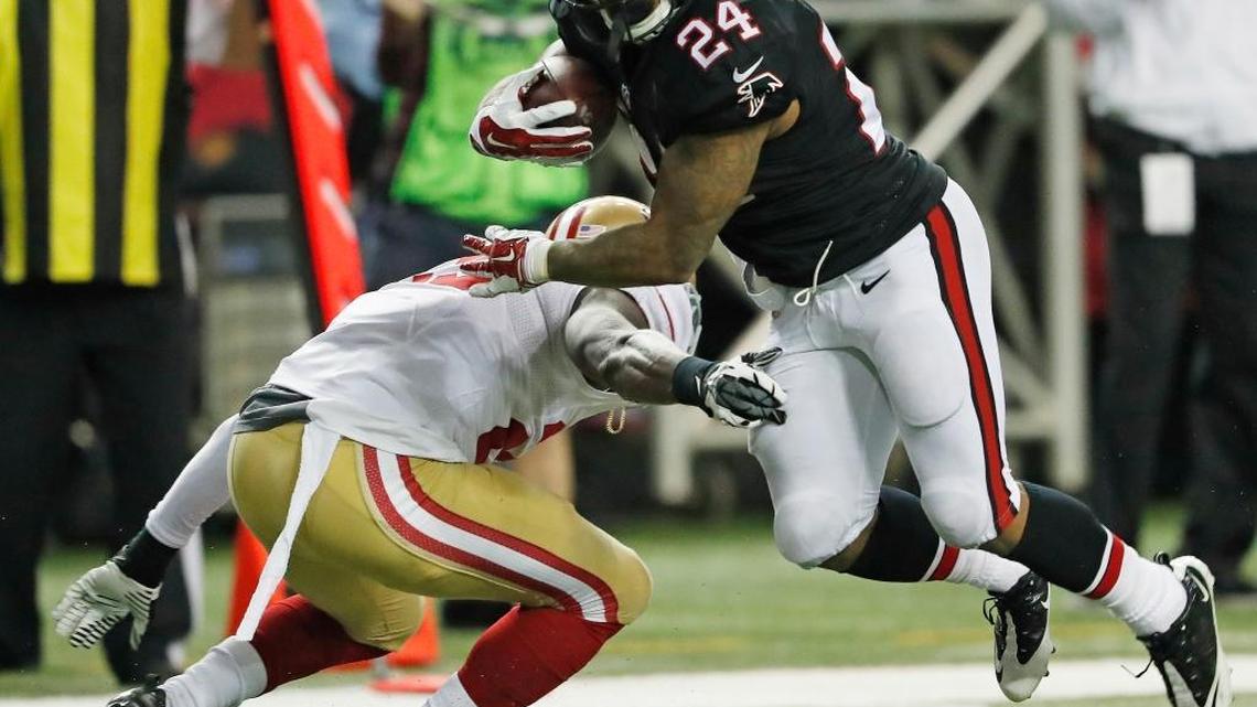 Atlanta Falcons running back Devonta Freeman runs past San Francisco free safety Jaquiski Tartt during the first half on Sunday, Dec. 18, 2016, in Atlanta. Freeman rushed for 139 yards and three touchdowns.