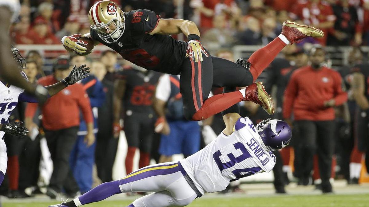 
San Francisco 49ers tight end Garrett Celek (88) is tackled by Minnesota Vikings strong safety Andrew Sendejo (34) during the first half of an NFL football game in Santa Clara, Calif., Monday, Sept. 14, 2015.
