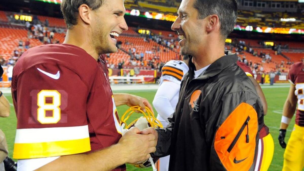 Washington Redskins quarterback Kirk Cousins (8) talks with Cleveland Browns offensive coordinator Kyle Shanahan after an NFL preseason football game Monday, Aug. 18, 2014, in Landover, Md.