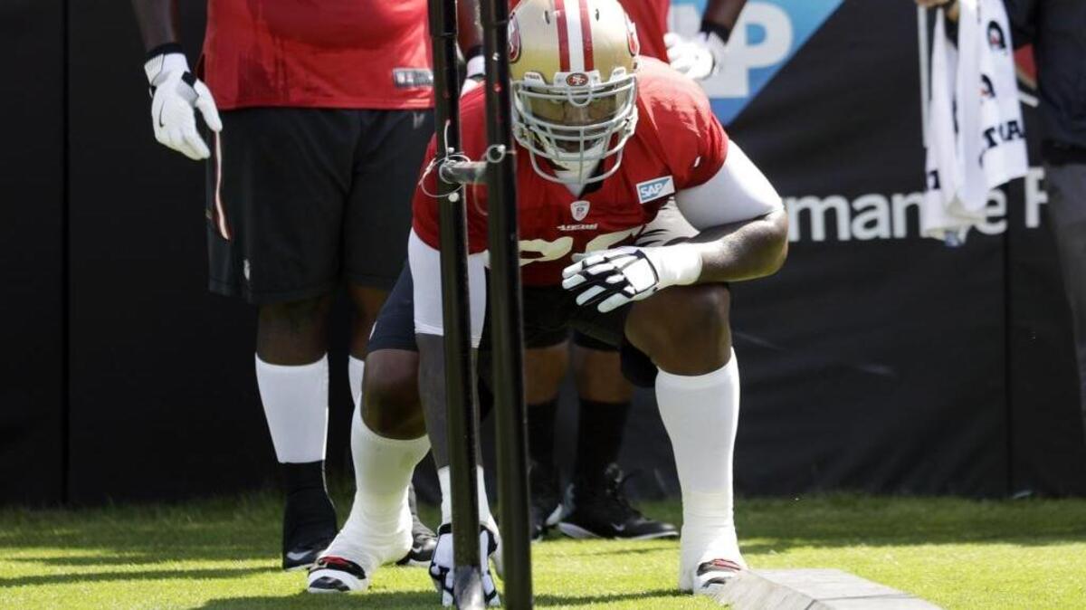 49ers offensive lineman Anthony Davis goes through drills during training camp on Sunday in Santa Clara.