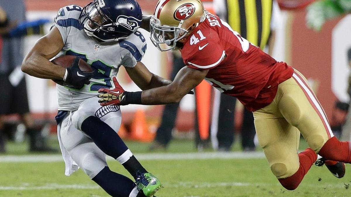 San Francisco 49ers strong safety Antoine Bethea (41) tackles Seattle Seahawks wide receiver Doug Baldwin (89) during the first half of an NFL football game in Santa Clara, Calif., Thursday, Oct. 22, 2015.